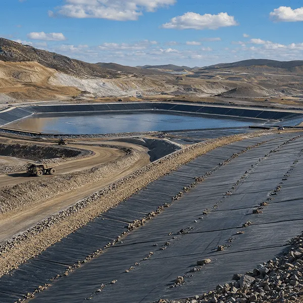 Geosynthetic containment and drainage system for mining engineering